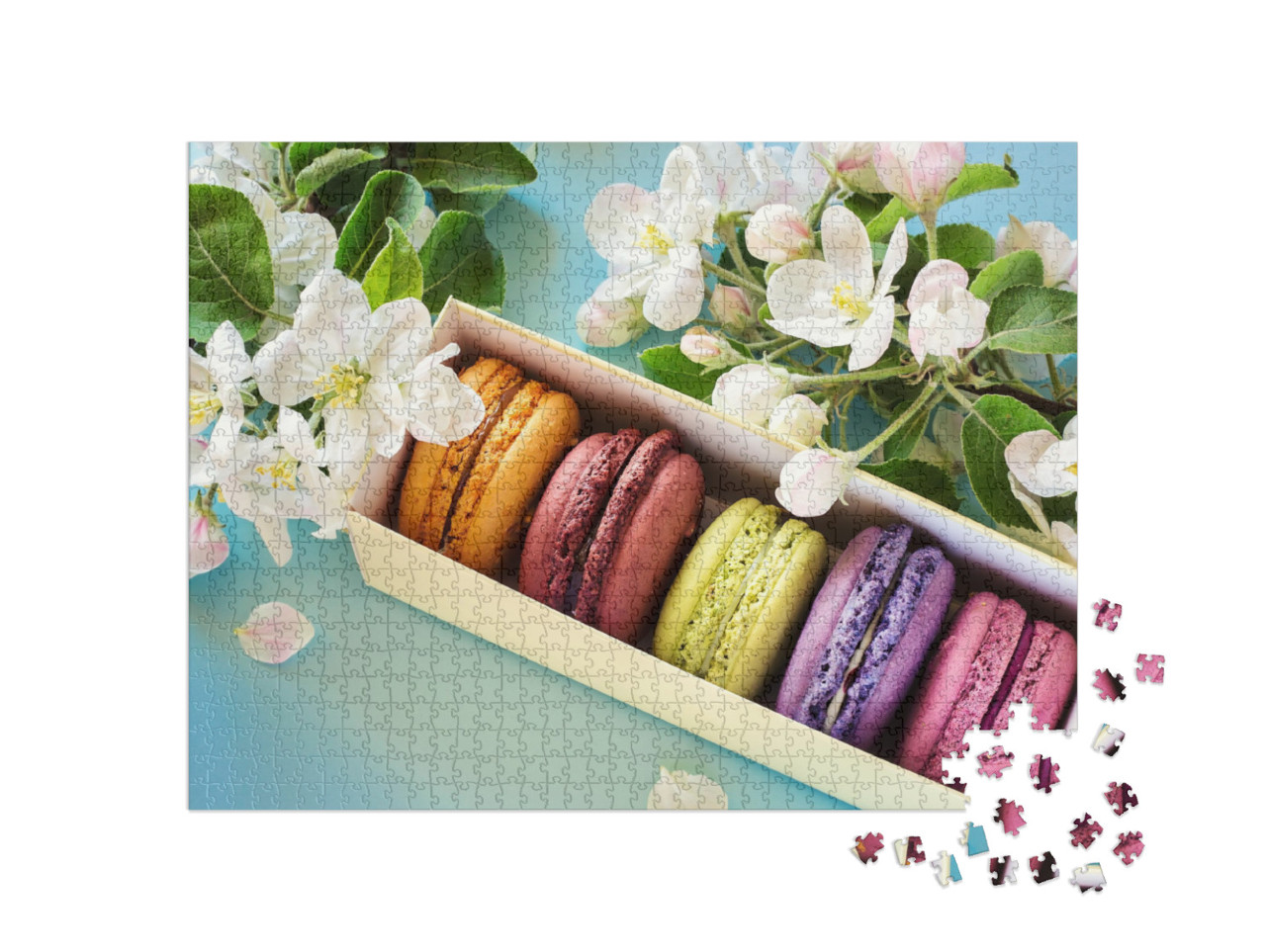 Puzzle 1000 Teile „Schachtel mit bunten Makarons, umrahmt von Apfelblüten“