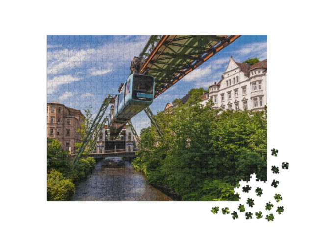 Puzzle 1000 Teile „Die Schwebende Straßenbahn in Wuppertal“