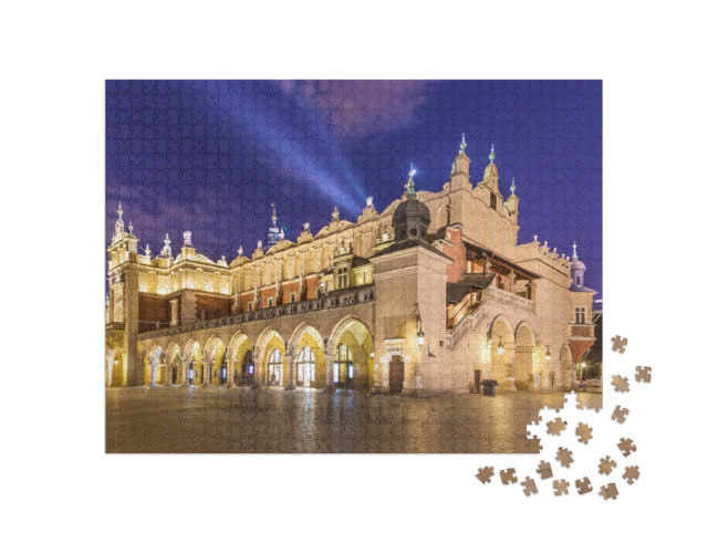Puzzle 1000 Teile „Sukiennice auf dem Hauptmarkt bei Nacht, Krakau, Polen“
