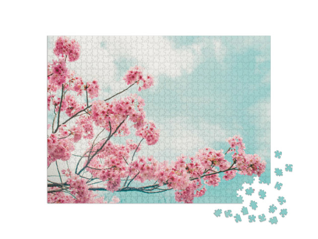 Puzzle 1000 Teile „Wunderschön blühender Kirschblütenzweig vor blauen Himmel“