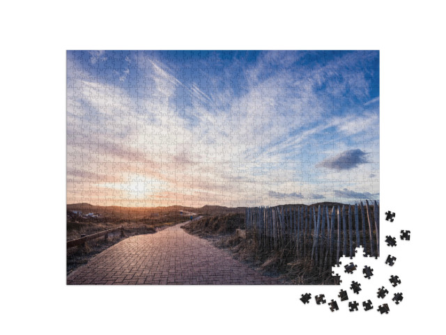 Puzzle 1000 Teile „Wolken über dem Radweg auf Norderney“