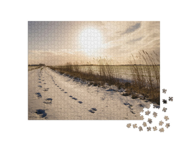 Puzzle 1000 Teile „Fußspuren durch den Schnee, Ostfriesland“