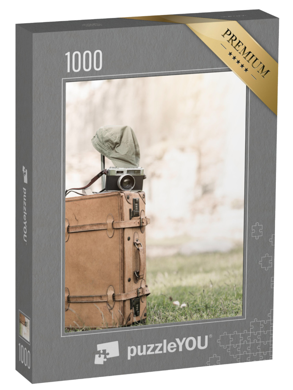 Puzzle 1000 Teile „Vintage-Kamera auf einer alten Gepäcktasche im Gras“