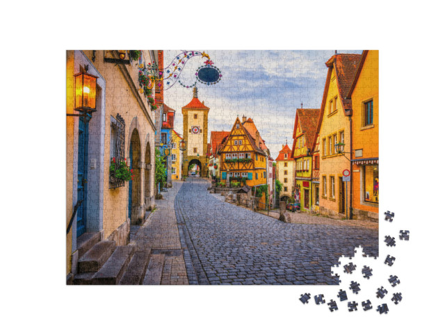 Puzzle 1000 Teile „Morgenansicht der Unteren Schmiedgasse in Rothenburg ob der Tauber, Bayern“
